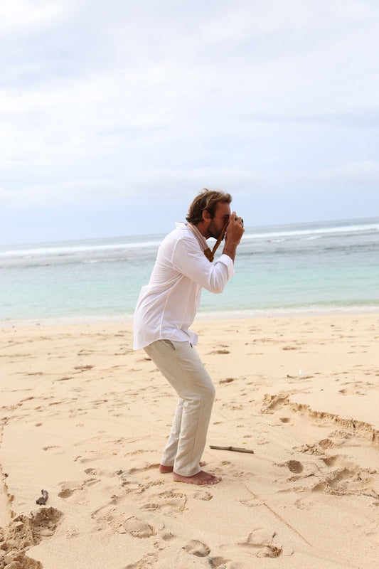 white linen shirt with cream pants on the beach