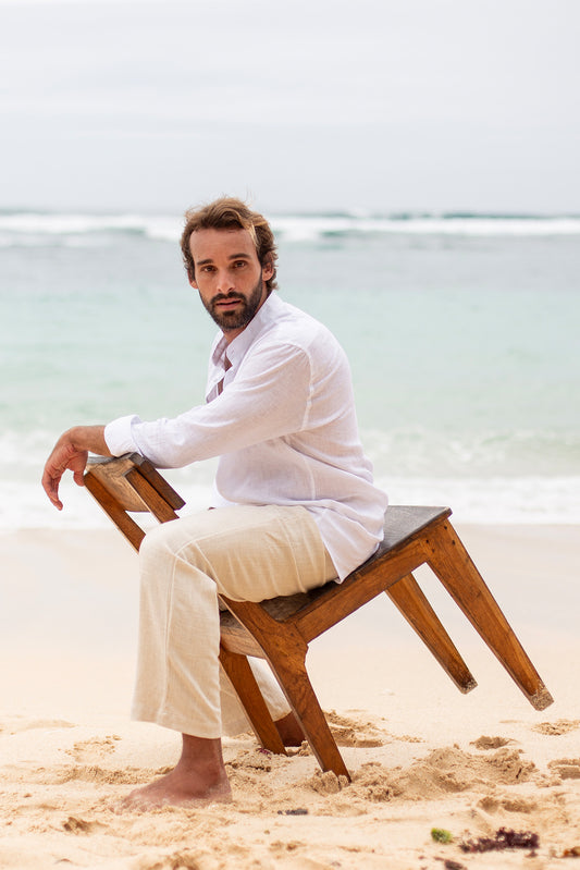 Model wearing cream thick linen pants and a white shirt.